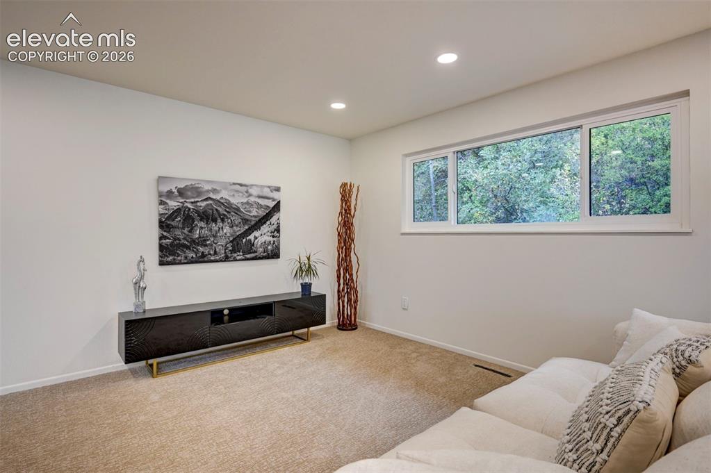 Image 23 of 50: Interior space featuring neutral wall tones, recessed lighting, and a wide 