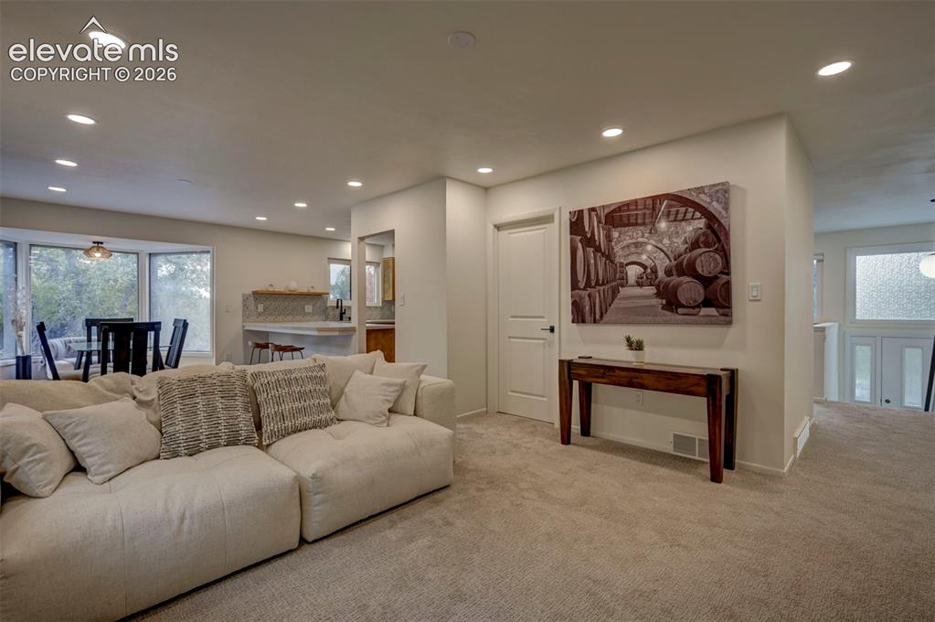Image 25 of 50: Neutral-toned carpet, recessed lighting, multi-panel interior door, and tex