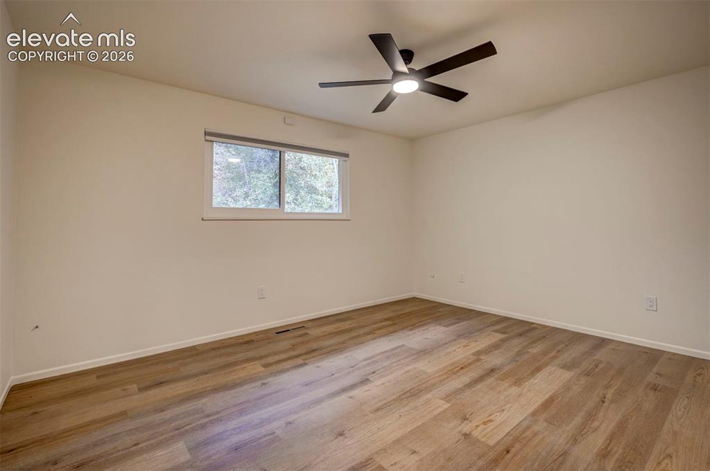 Image 26 of 50: Interior space featuring wood-finish flooring, neutral wall paint, and a ma