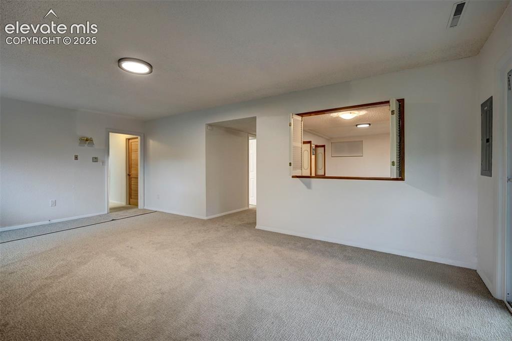 Image 42 of 50: Neutral-toned wall-to-wall carpeting, flush-mount ceiling lighting, and a b