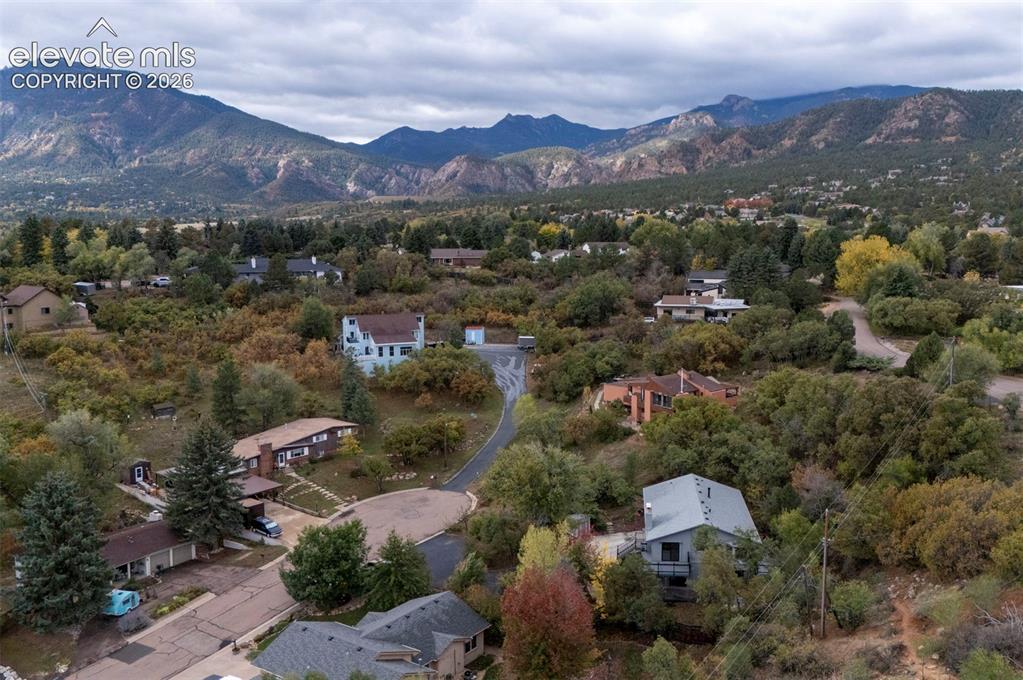 Image 6 of 50: Aerial perspective featuring extensive mountain range backdrop, mature ever