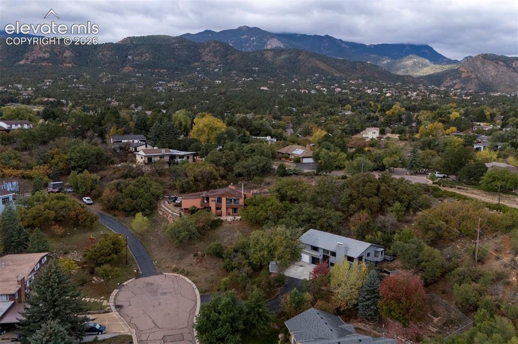 Image 7 of 50: Aerial perspective featuring a hillside landscape with mountain backdrops,