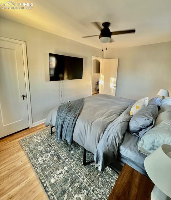 Image 10 of 25: Bedroom featuring ceiling fan and light wood flooring