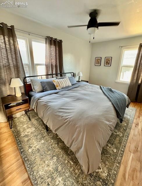 Image 12 of 25: Bedroom featuring light wood flooring and ceiling fan