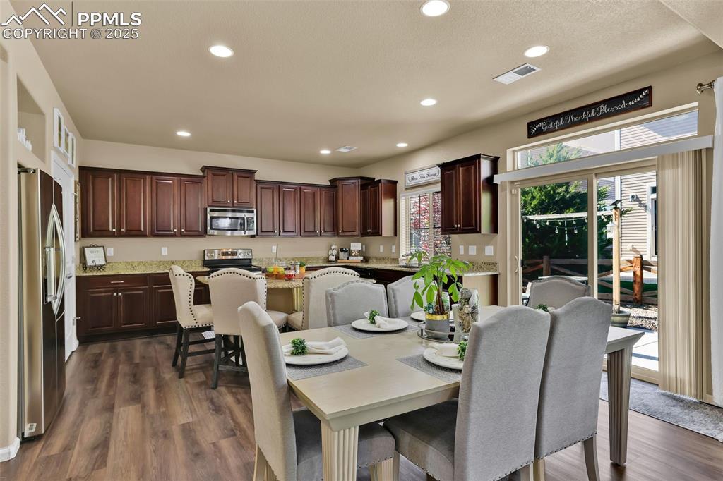 Image 10 of 50: Dining area featuring lvp flooring, recessed lighting