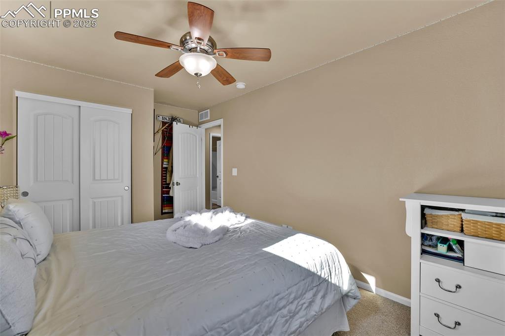 Image 26 of 50: Bedroom with a closet, baseboards, ceiling fan, visible vents, and light ca