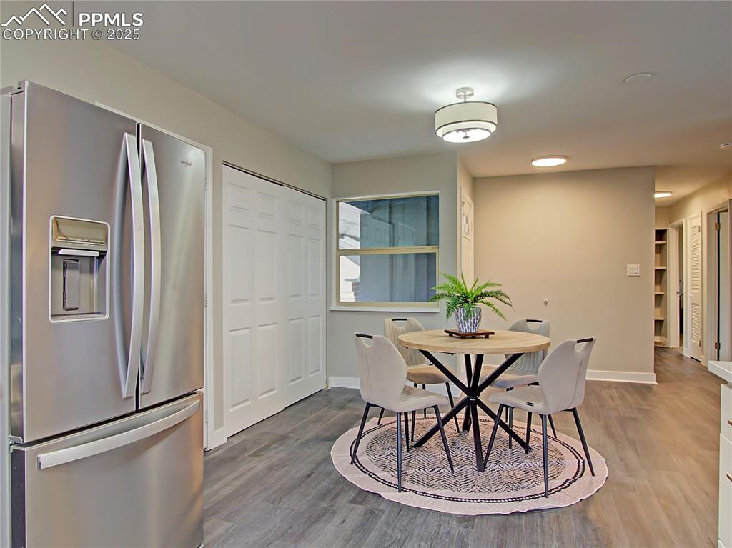 Image 10 of 26: Dining space with wood finished floors