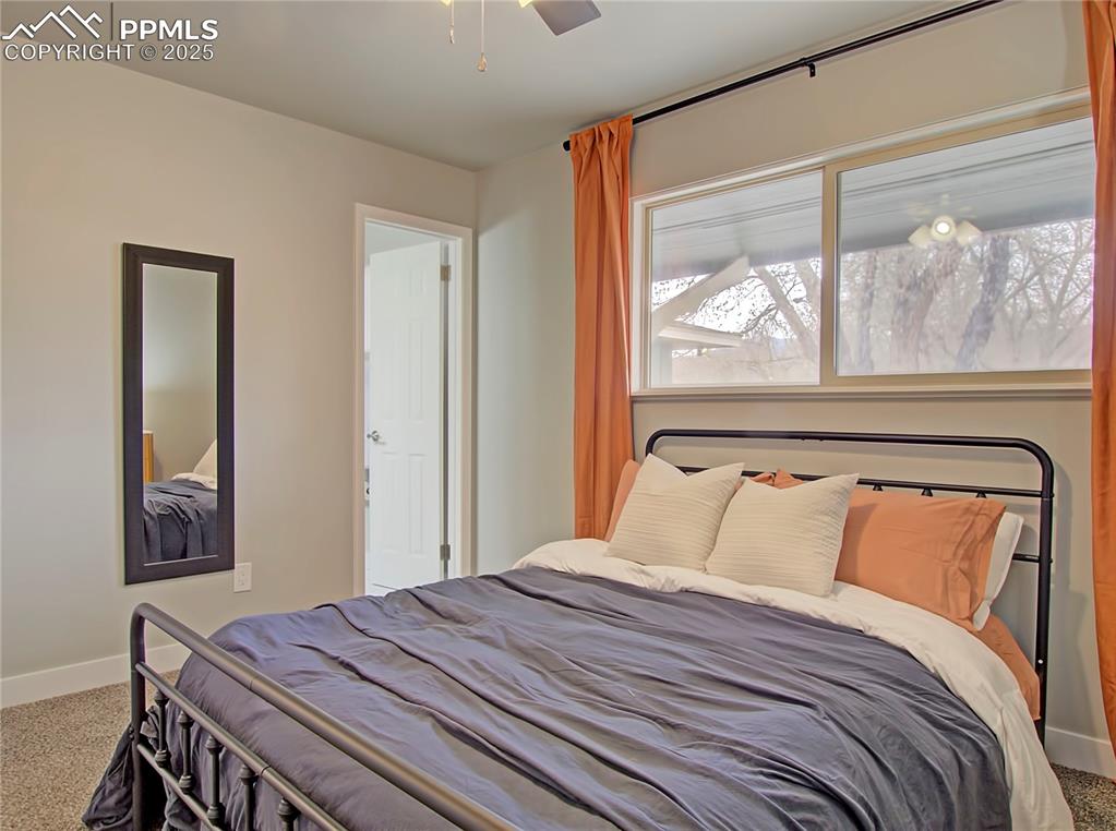 Image 21 of 26: Bedroom with carpet and ceiling fan