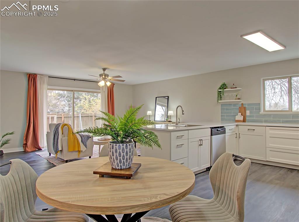 Image 5 of 26: Dining space featuring healthy amount of natural light, dark wood-type floo