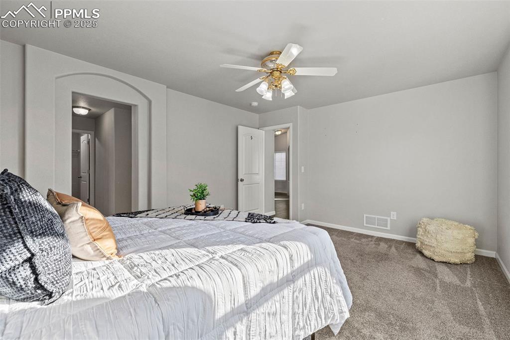 Image 15 of 42: Carpeted bedroom with baseboards and a ceiling fan