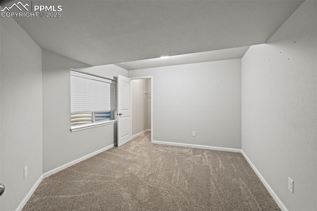 Image 25 of 42: Carpeted empty room featuring baseboards