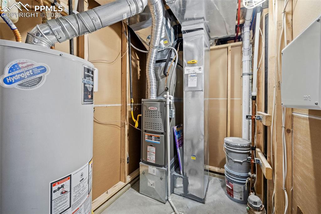 Image 29 of 42: Utility room featuring water heater and heating unit