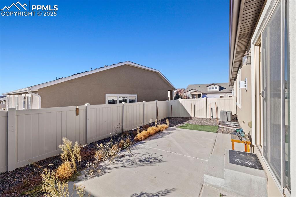 Image 30 of 42: Fenced backyard featuring a patio