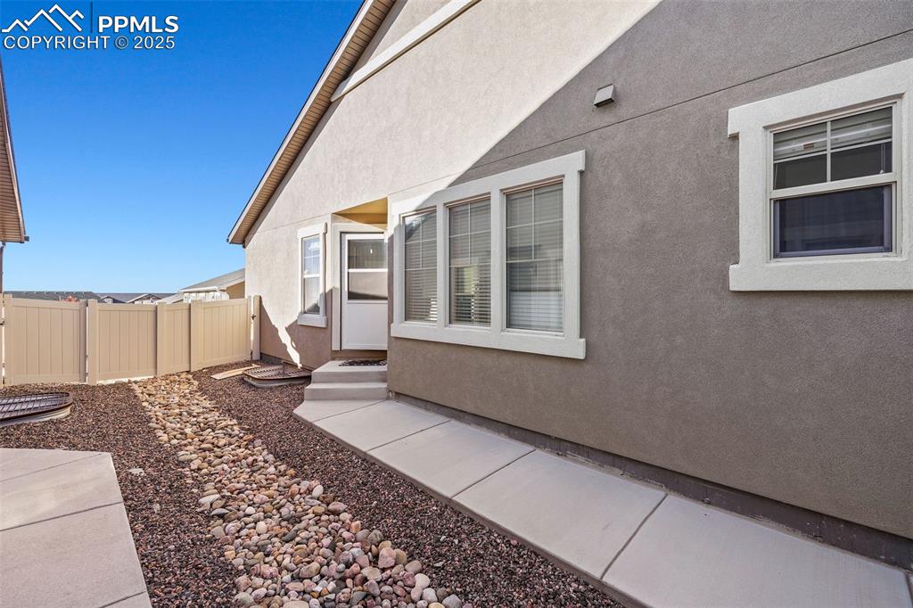 Image 31 of 42: View of side of home featuring stucco siding