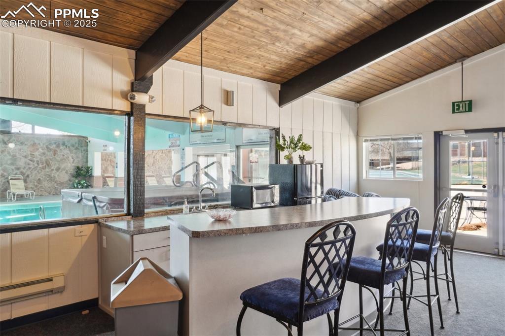 Image 43 of 43: Recreation area with Kitchen featuring a baseboard radiator, a kitchen brea