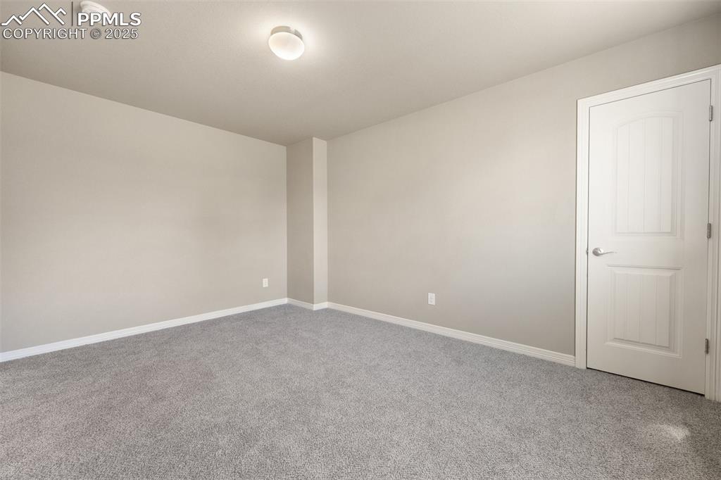Image 11 of 25: Empty room with carpet and a smoke detector