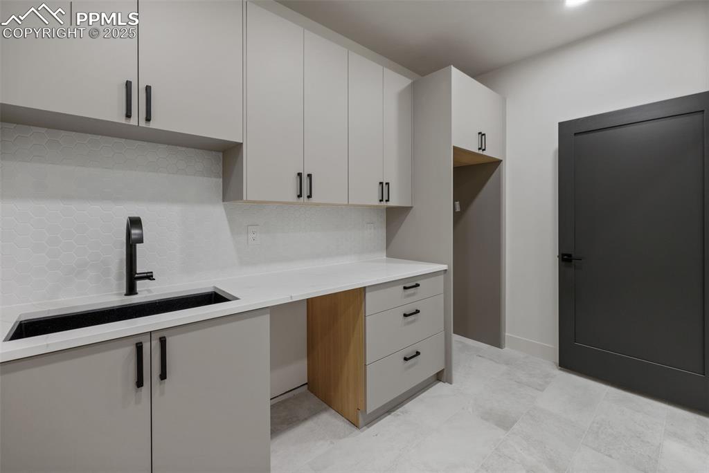 Image 42 of 50: 2nd laundry in basement has kitchenette. 