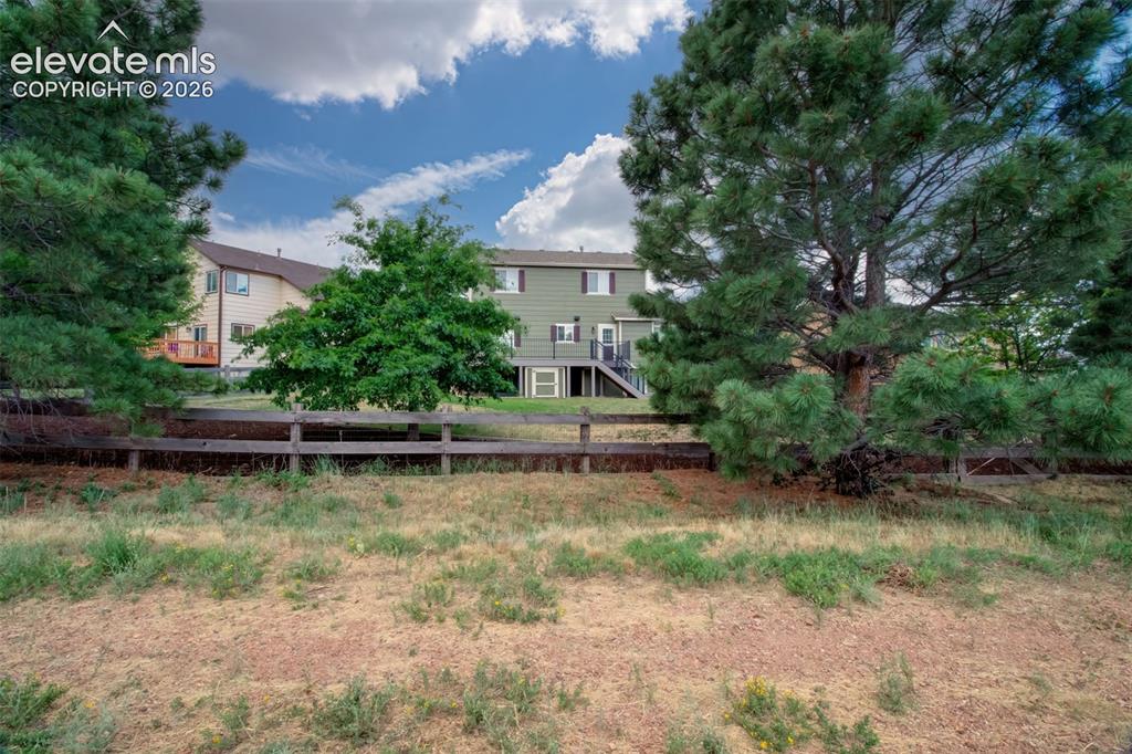 Image 41 of 47: Open Space behind the home with a trail