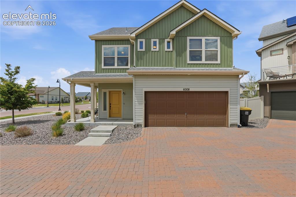 Image 1 of 48: Contemporary two-story residence featuring a covered front porch, a two-car