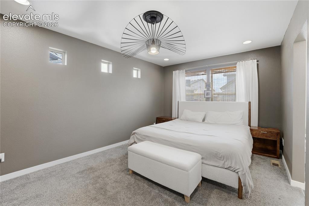 Image 19 of 48: Spacious room featuring neutral-toned walls, recessed lighting, and a conte