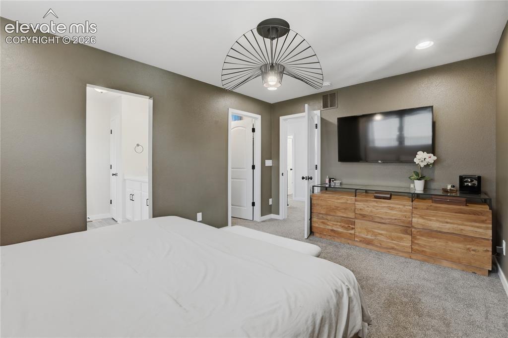 Image 21 of 48: Carpeted bedroom featuring an overhead ceiling fixture, recessed lighting,