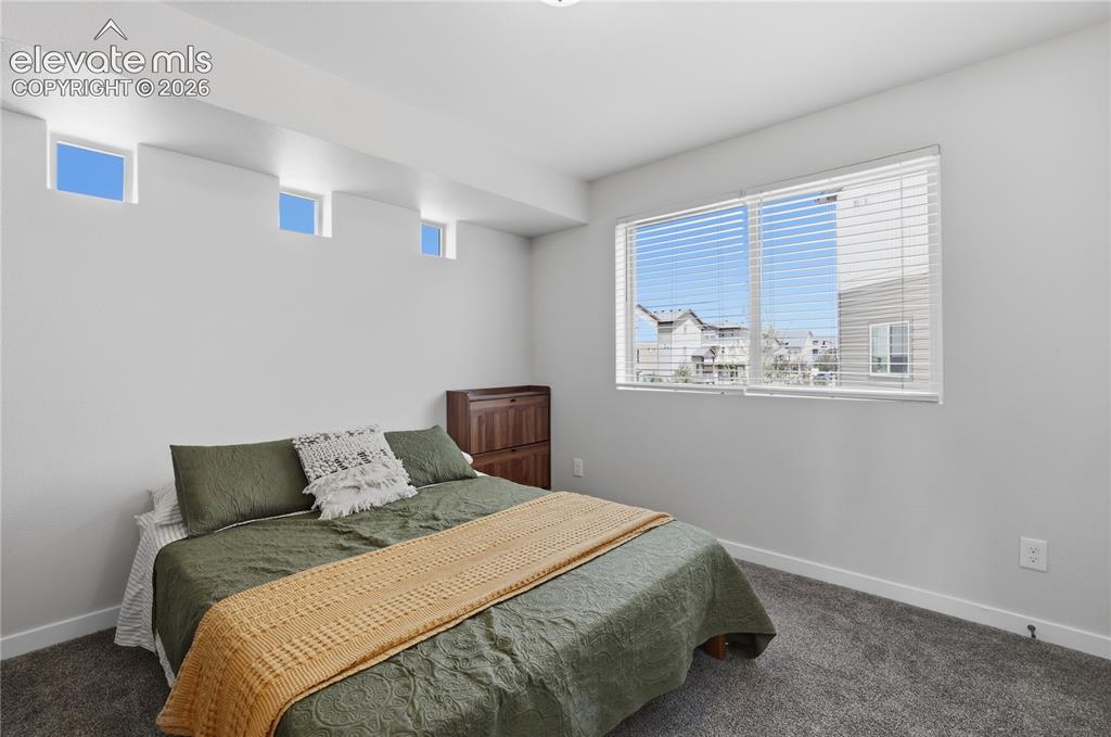 Image 25 of 48: Spacious room featuring a large window with blinds, three transom windows,