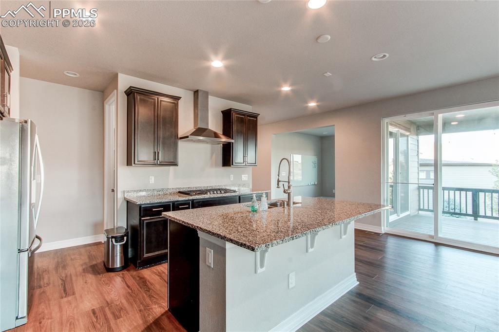 Image 19 of 49: Kitchen featuring light stone counters, stainless steel appliances, a kitch