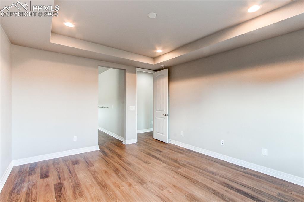Image 32 of 49: Empty room featuring recessed lighting, light wood-type flooring, and a rai