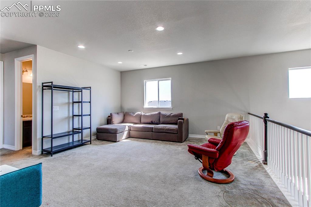 Image 38 of 49: Carpeted living area featuring baseboards and recessed lighting