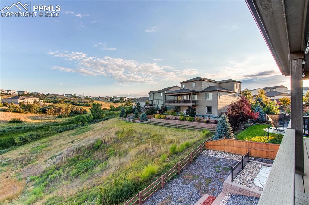 Image 4 of 49: Fenced backyard with a balcony and a residential view