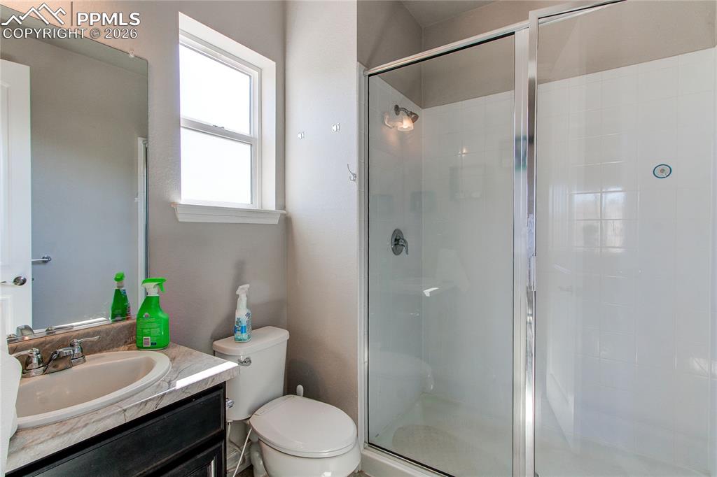 Image 40 of 49: Full bath with vanity and a stall shower