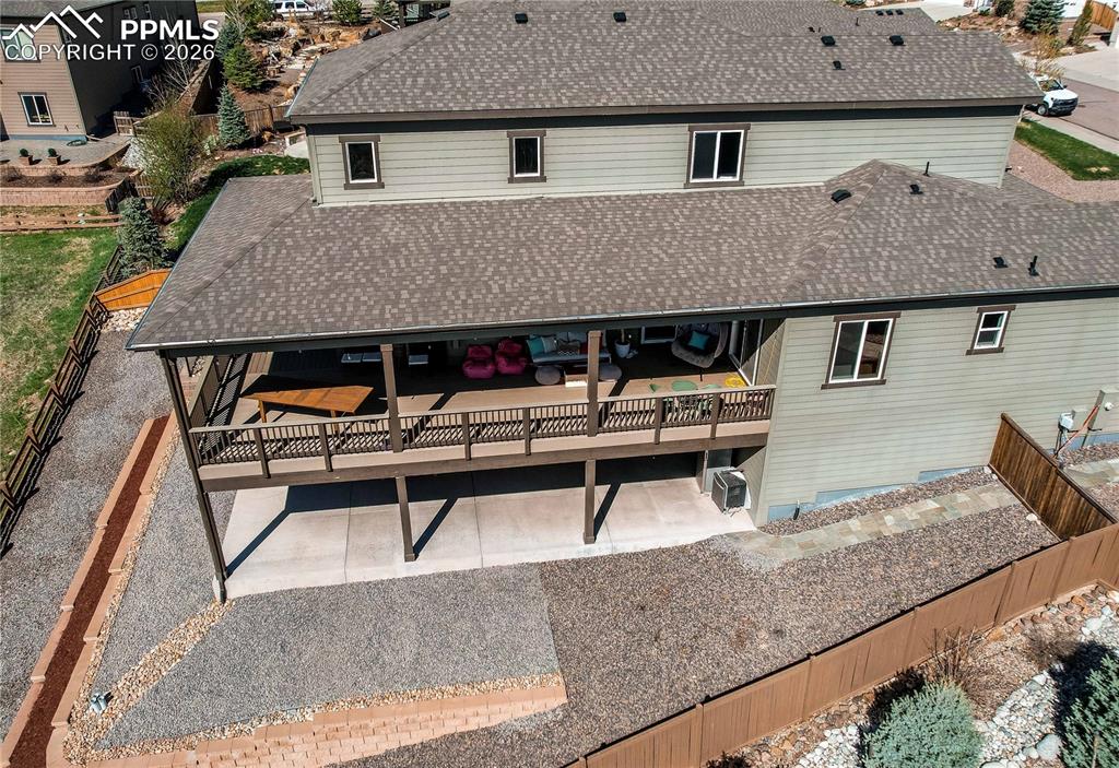 Image 46 of 49: Rear view of house with roof with shingles, a wooden deck, a fenced backyar
