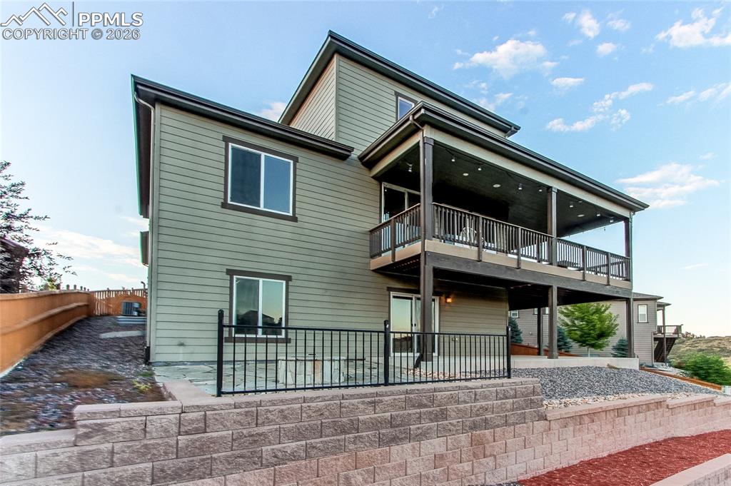 Image 8 of 49: Back of house with a patio