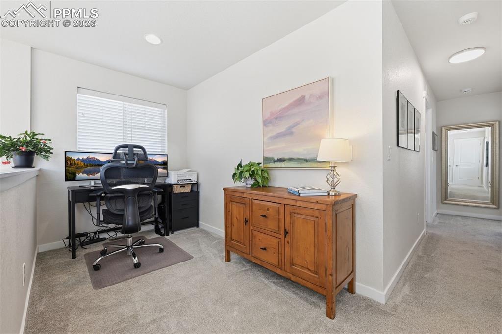 Image 19 of 32: Loft space with window and carpet
