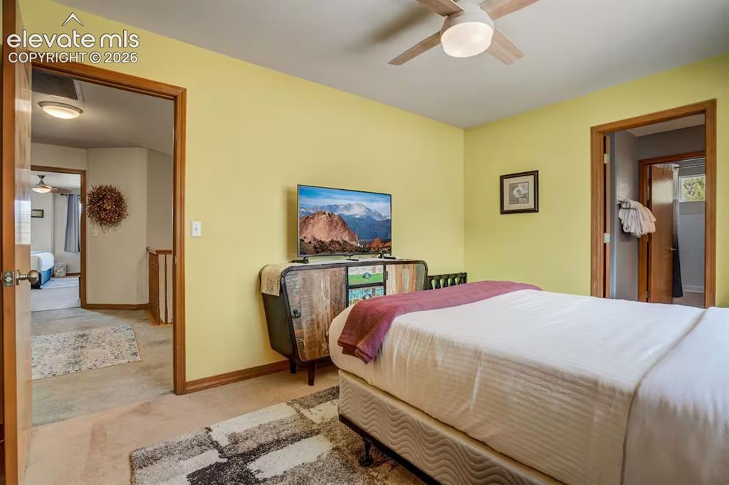 Image 18 of 45: Carpeted room with light yellow walls and a ceiling fan with integrated lig