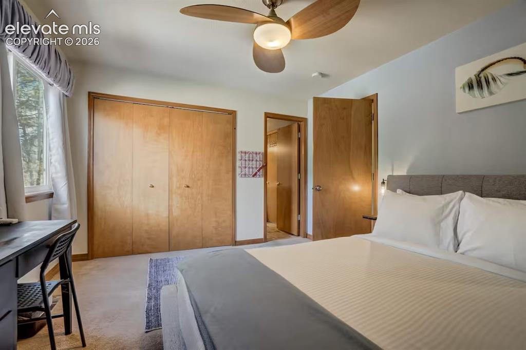 Image 34 of 45: Room featuring light-colored carpet flooring, a window with drapery, wood-f