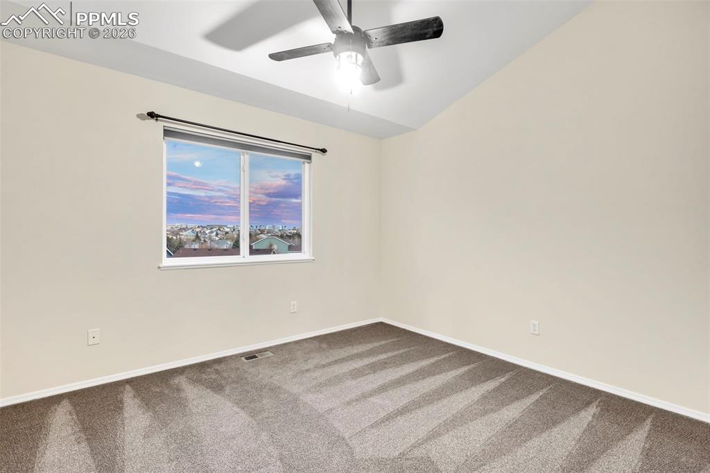 Image 30 of 50: Unfurnished bedroom with carpet flooring and a ceiling fan