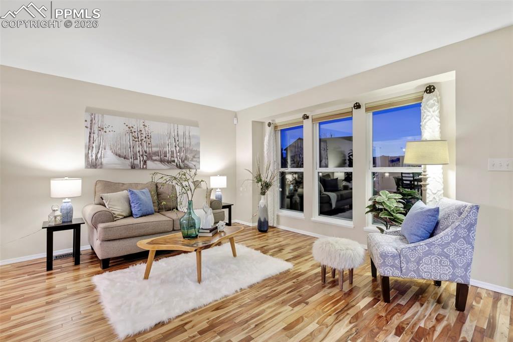 Image 6 of 50: Living area featuring light wood-type flooring