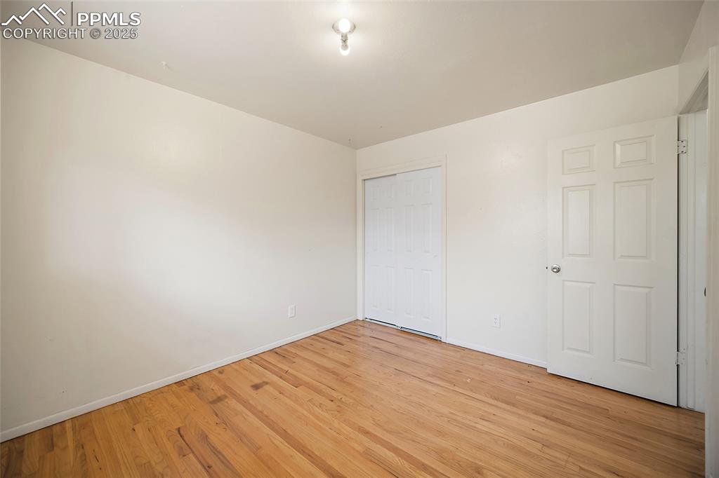 Image 10 of 19: Unfurnished bedroom featuring light wood-type flooring and a closet