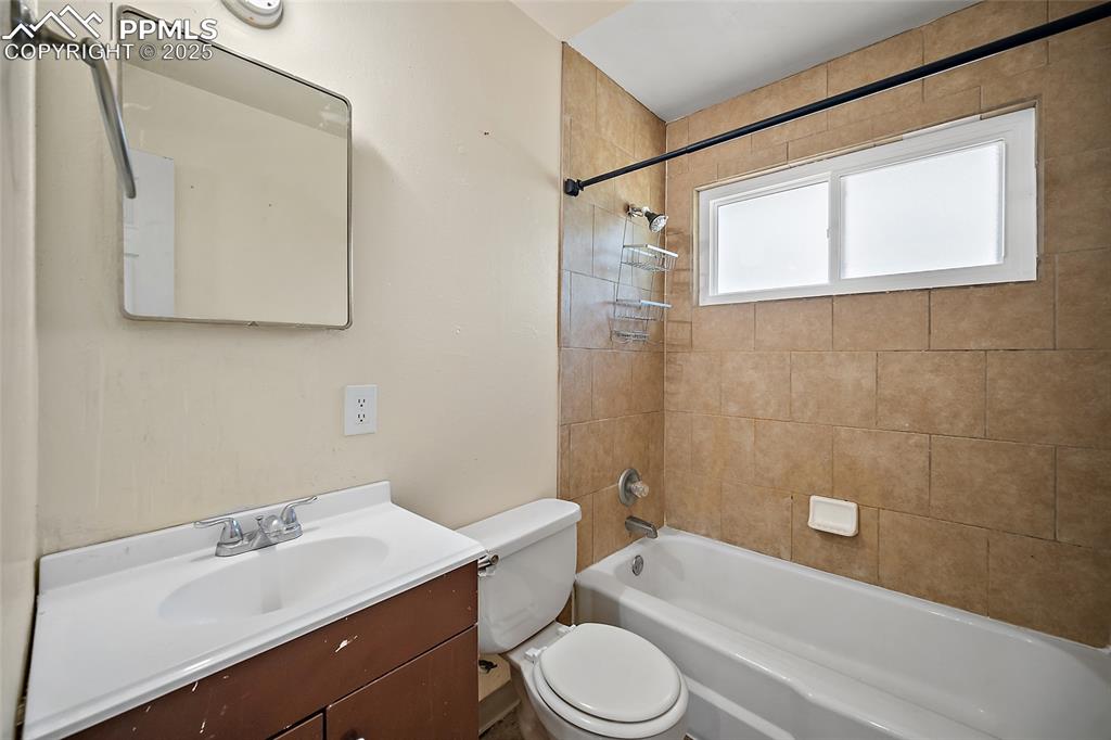 Image 11 of 19: Bathroom with shower combination and vanity