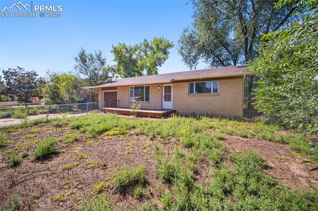 Image 2 of 19: Ranch-style house featuring brick siding and a garage