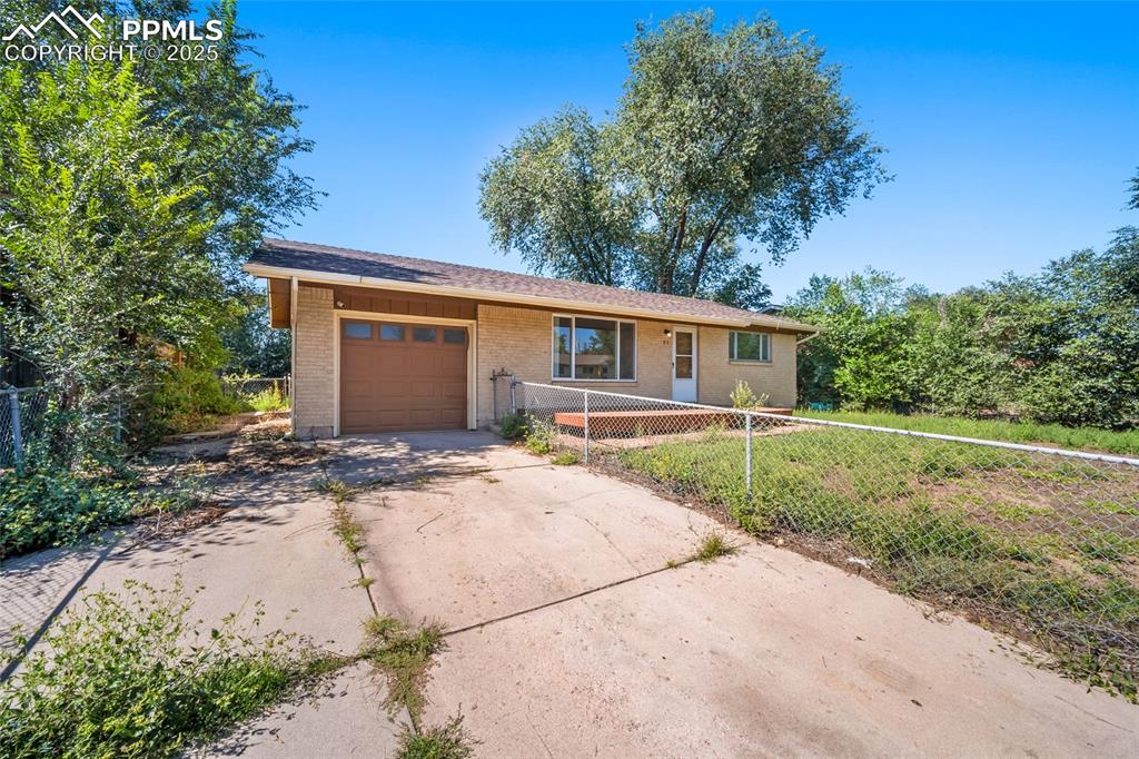 Image 3 of 19: Single story home featuring concrete driveway, a garage, and brick siding