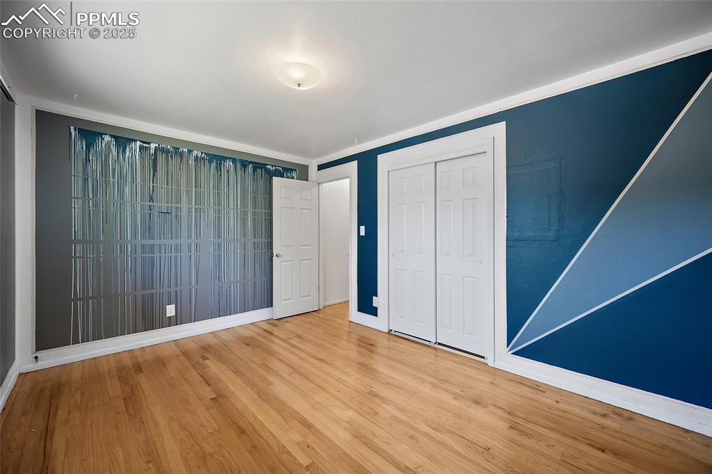 Image 8 of 19: Unfurnished bedroom featuring a closet and wood finished floors
