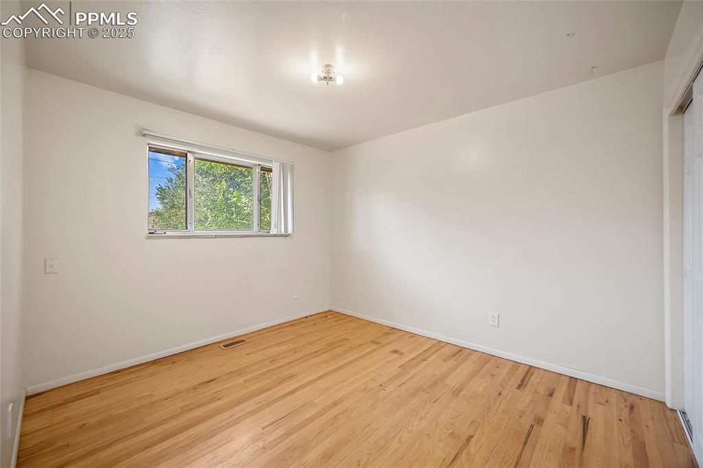 Image 9 of 19: Empty room with light wood-style floors