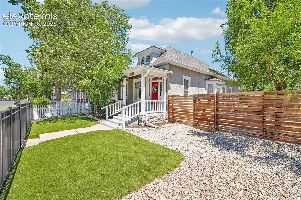 Image 2 of 40: Fenced front yard with astro turf