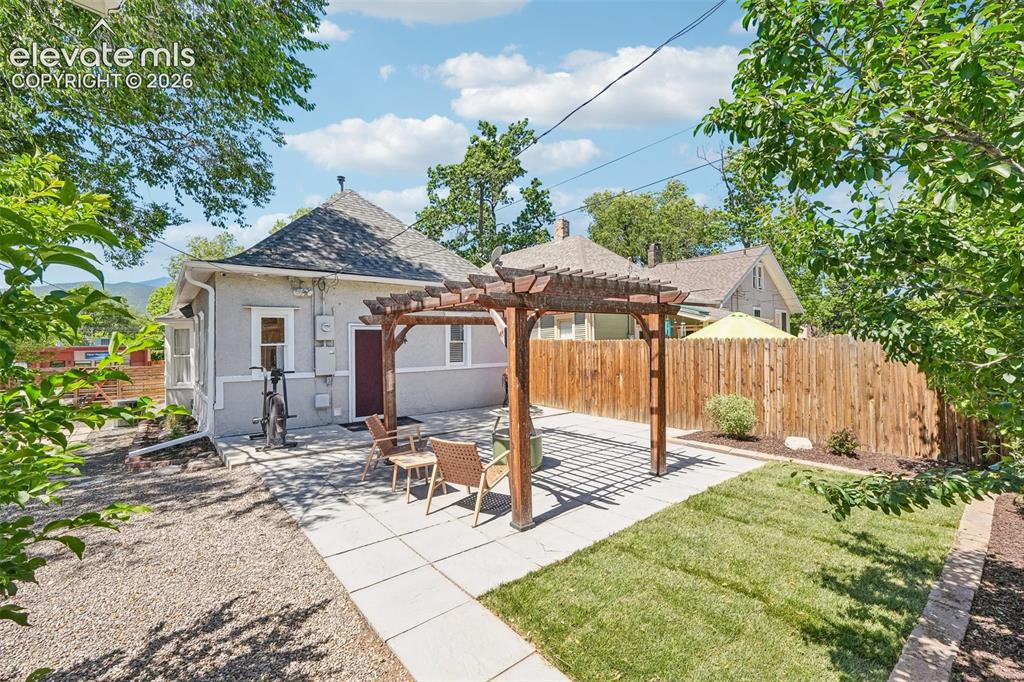 Image 31 of 40: Back patio with pergola