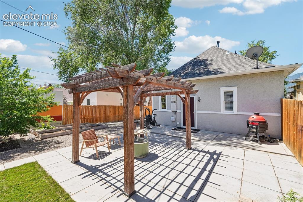 Image 32 of 40: Back patio with pergola