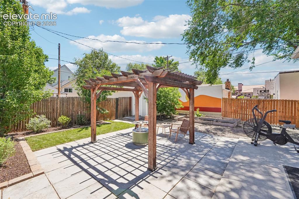 Image 33 of 40: Back patio with pergola