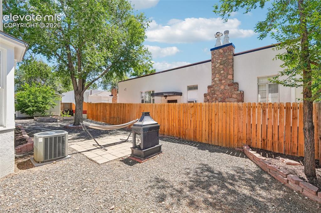 Image 36 of 40: Backyard with wood burning fireplace