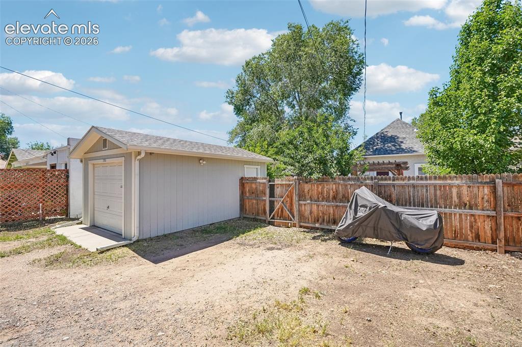 Image 38 of 40: Detached 1 car garage with extra parking spaces or Rv parking